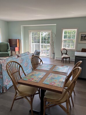 Spry 3 dining area and balcony overlooking the water.