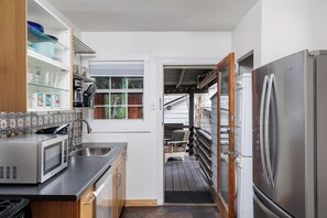 Well equipped kitchen along with a wash/dryer. Easy access through the back door to the patio. 