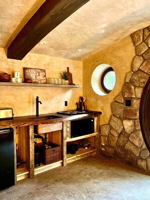 Electric cooktop, microwave oven and hobbit-style plates and silverware will make you feel right at home in the Shire.