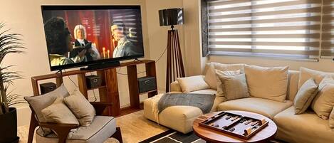 Sala de estar con un elegante sofá y un televisor