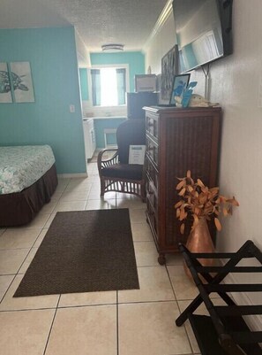 View from entry door to kitchen, showing dresser and suitcase stand