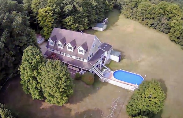 Drone photo of the peaceful and private 11 acres.  12 beds, 7 baths home.