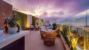 A rooftop with swimming pools, bar and a panoramic view of the sea and the city.