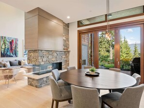 Dining area for eight people with large glass sliding doors that open onto a private patio