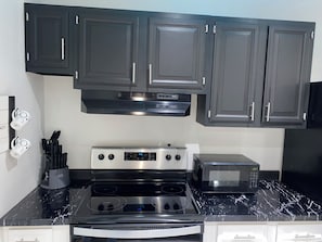 Full kitchen with stove, oven, miocrowave and refrigerator