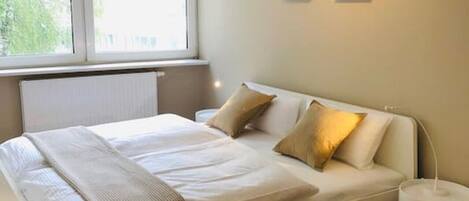 Soft and cozy double bed with pillows to have a good night sleep during your stay.