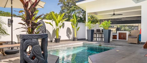 Private pool, outdoor kitchen, and seating. 