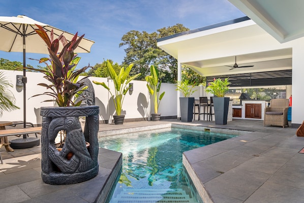 Private pool, outdoor kitchen, and seating. 