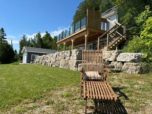 The property not only offers ample parking with a double driveway but also boasts 99 feet of pristine shoreline, promising endless adventures and a deep connection with nature.
