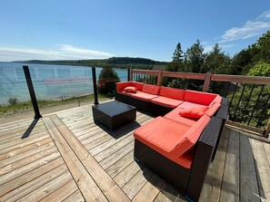 Entertainment and leisure are effortless, thanks to the new oversized deck with glass railings, providing a perfect backdrop for gatherings, celebrations, or quiet reflection as you gaze out over the water.