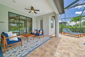 Villa Paradise at The Preserve - The screened in pool area offers a lounge area, a covered seating area and BBQ