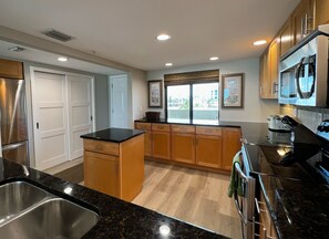 Plenty of counter and cabinet space in this chef's kitchen at th - Plenty of counter and cabinet space in this chef's kitchen at the front entrance of the unit. Plus, a beachfront view from the kitchen!