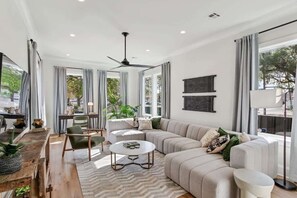 Bright, open-concept living area with plush sectional couch.