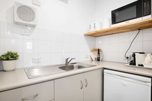 Kitchenette, featuring mini fridge/freezer, kettle, coffee pod machine,toaster, mircrowave and hot plate