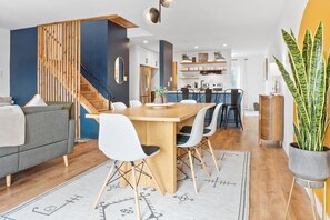 The open living room/dining/kitchen is a light-filled space with a modern Scandinavian style and a great layout for socializing and entertaining.