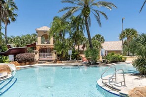 Enjoy the sunshine by this sparkling pool surrounded by lush greenery and beautiful landscaping.