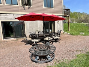 Fire pit grill. Patio doors lead to downstairs of dwelling.