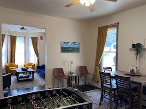 Dining room with table for 6. Foosball and dartboard.