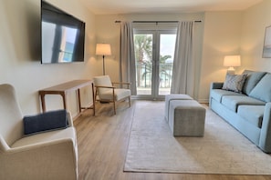 Living room featuring Gulf and palm tree views. 