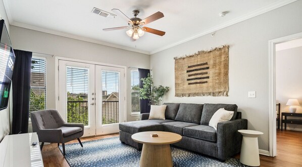 Open living room with sleeper sofa and smart tv