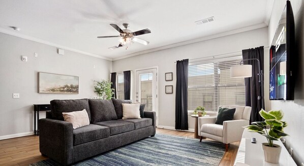 Open and large living room with sleeper sofa and smart tv