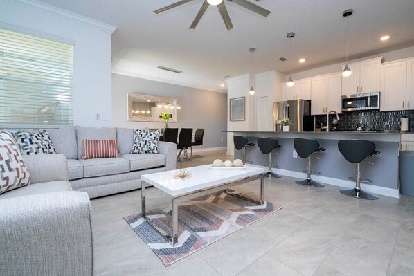 The fully equipped kitchen features modern appliances, sleek cabinetry, and all essential cookware and utensils, making it perfect for preparing meals with ease.