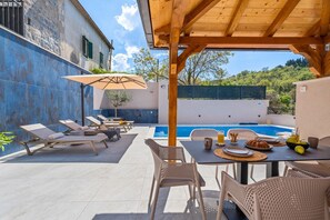 A fully fenced sun deck area with 6 deck chairs