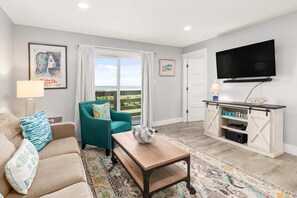 The living area with Queen-size sleeper sofa and balcony access