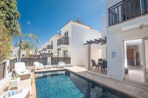 Garden with barbecue, seating area, shaded dining area, sun loungers and pool