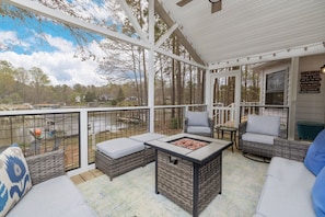 Screened-in porch with firepit and seating for plenty; overlooks Jimmie's Creek.