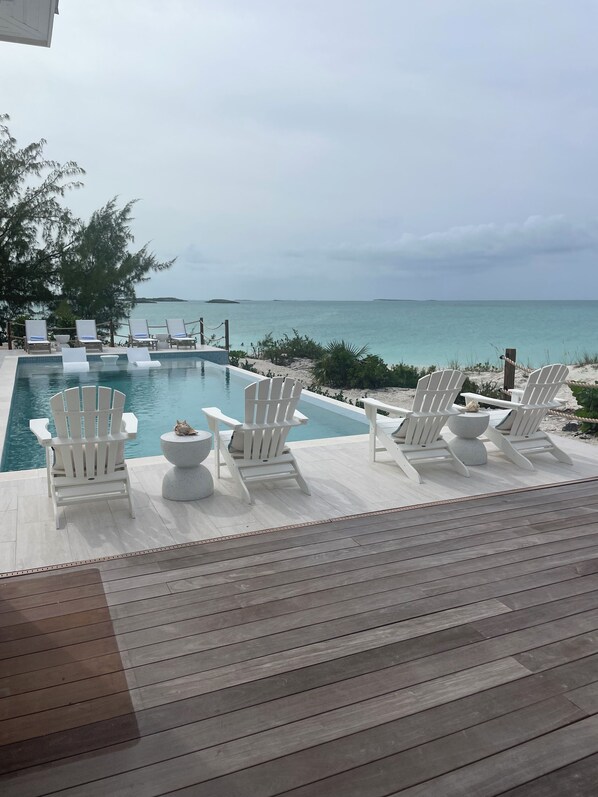 Deck with heated pool, sun ledge and loungers