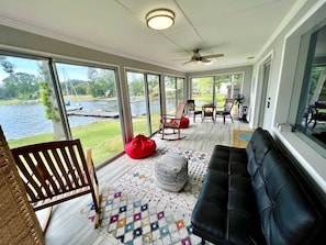 Screened in porch with panoramic sliding glass doors. Enough room to fit everyone for game night