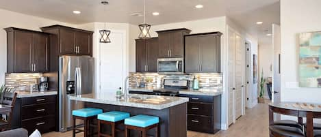 Kitchen View - The Kitchen Island comfortably seats 3 adults and creates a great space for serving and preparing meals.