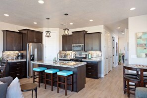 Kitchen View - The Kitchen Island comfortably seats 3 adults and creates a great space for serving and preparing meals.