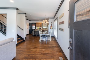 A spacious entryway welcomes you to the open concept Living, Dining, and Kitchen areas