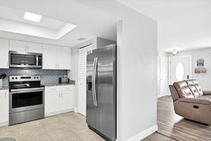 Well-stocked kitchen with many small appliances and Keurig Duo coffee maker.
