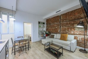 View of the living room space, dining room space and kitchen