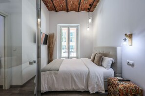 View of the bedroom with double bed and balcony