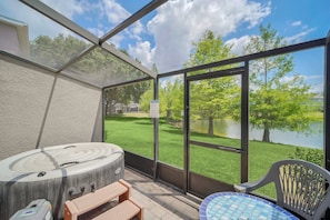 Screened patio with hot tub and lake view
