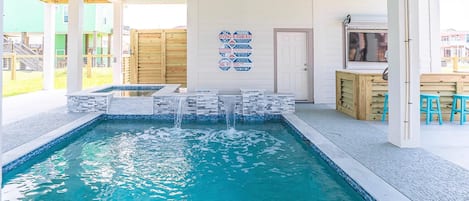 Hot tub with pool and waterfall feature