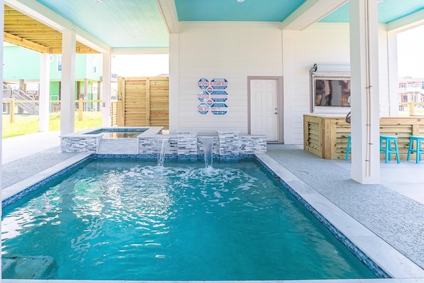 Hot tub with pool and waterfall feature