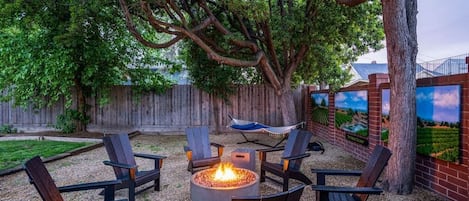 Escape to a backyard oasis: a mural by renowned local Lodi artist Tony Segale sets the scene, while a fire pit and hammock invite your group to relax and unwind.