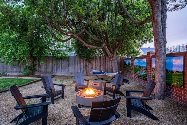 Escape to a backyard oasis: a mural by renowned local Lodi artist Tony Segale sets the scene, while a fire pit and hammock invite your group to relax and unwind.