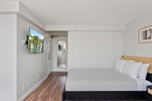 Room picture with TV, and queen bed