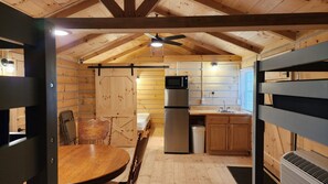 Kitchen area with microwave & refrigerator/freezer.