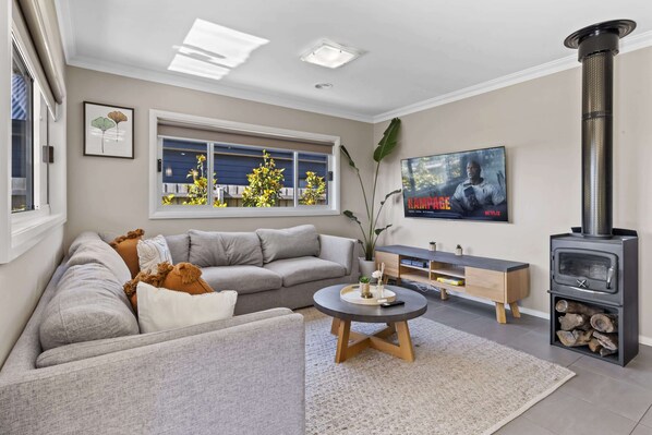 Living room with 65" TV and fireplace