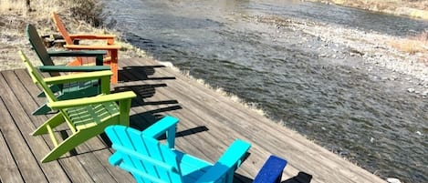 River Deck with six adirondack chairs. 