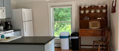 Kitchen with 4 burner range, refrigerator, microwave, and dishwasher. 