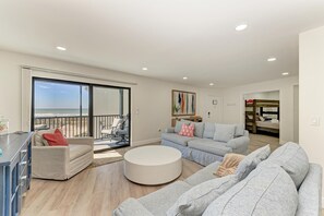 Living room looking out to covered screened in porch