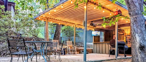 Outdoor bar & grill, refrigerator, sink with granite countertops.